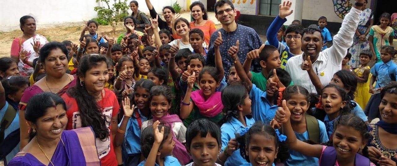 Vidhyadaanam volunteers and students celebrating together at a school event